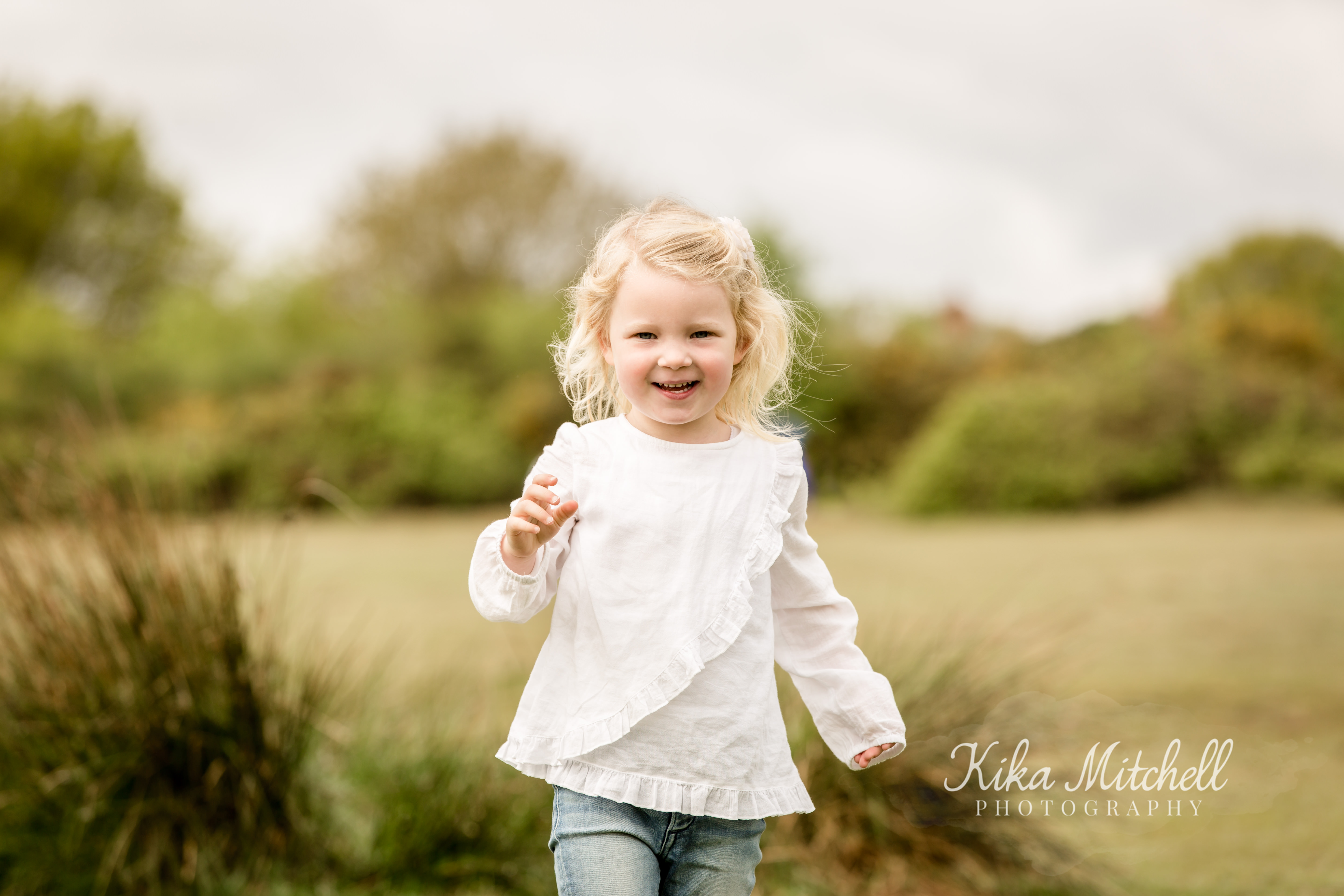 girl running on photoshoot with Chelmsford family photographer Kika Mitchell 