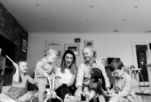 family of 6 all sat on floor having fun, mum laughing captured by Chelmsford family photographer Kika Mitchell Photography