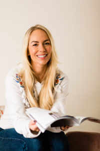 Headshot of Emily Norris sat reading magazine by Chelmsford photographer Kika Mitchell taken at her Brentwood home