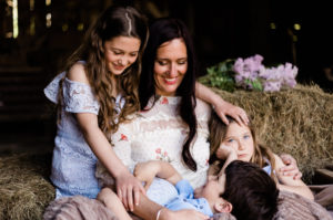 mother surrounded by children in colour portrait of motherhood by Kika Mitchell Photography
