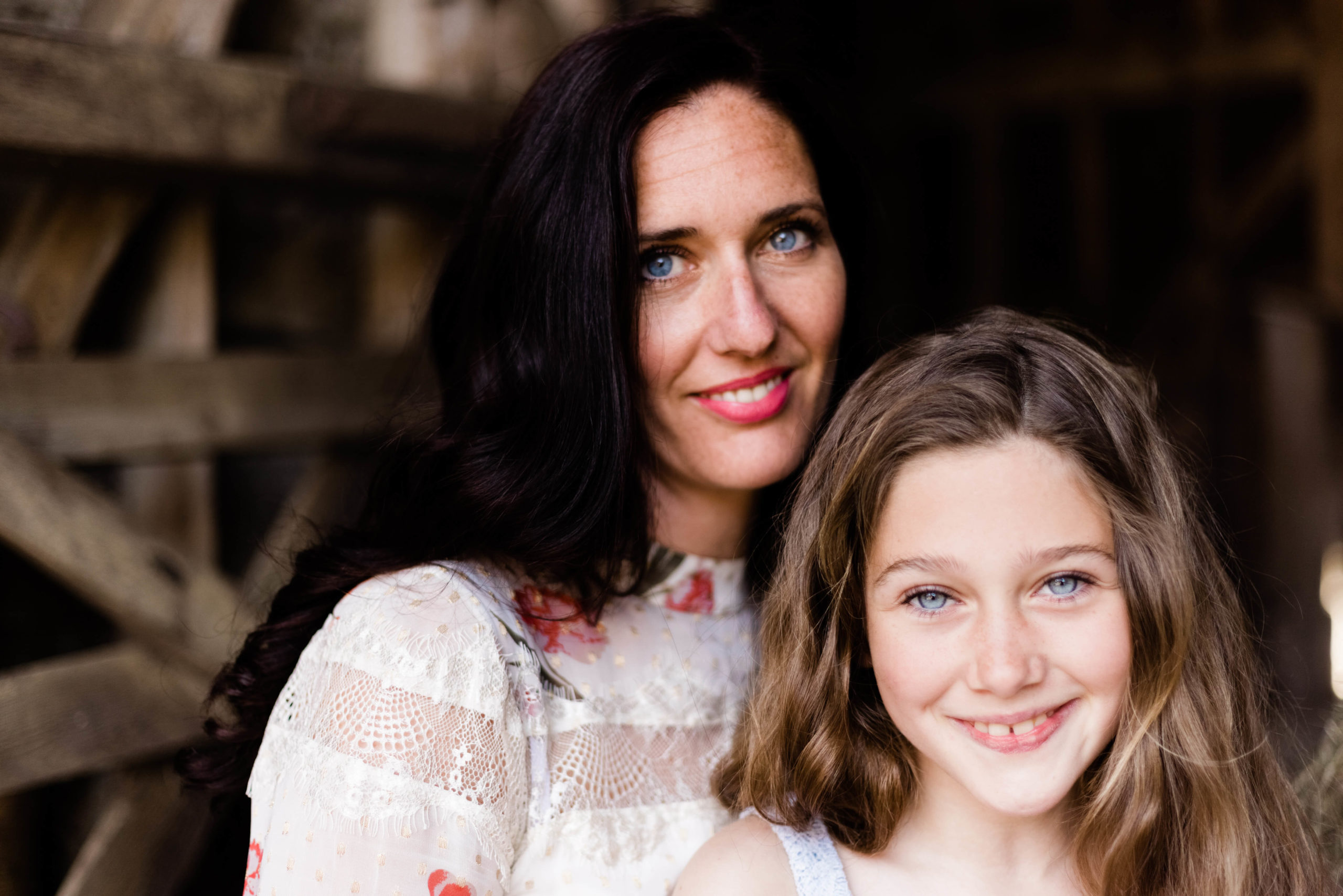 landscape image of mum and daughter in barn by Kika Mitchell photography Chelmsford photographer