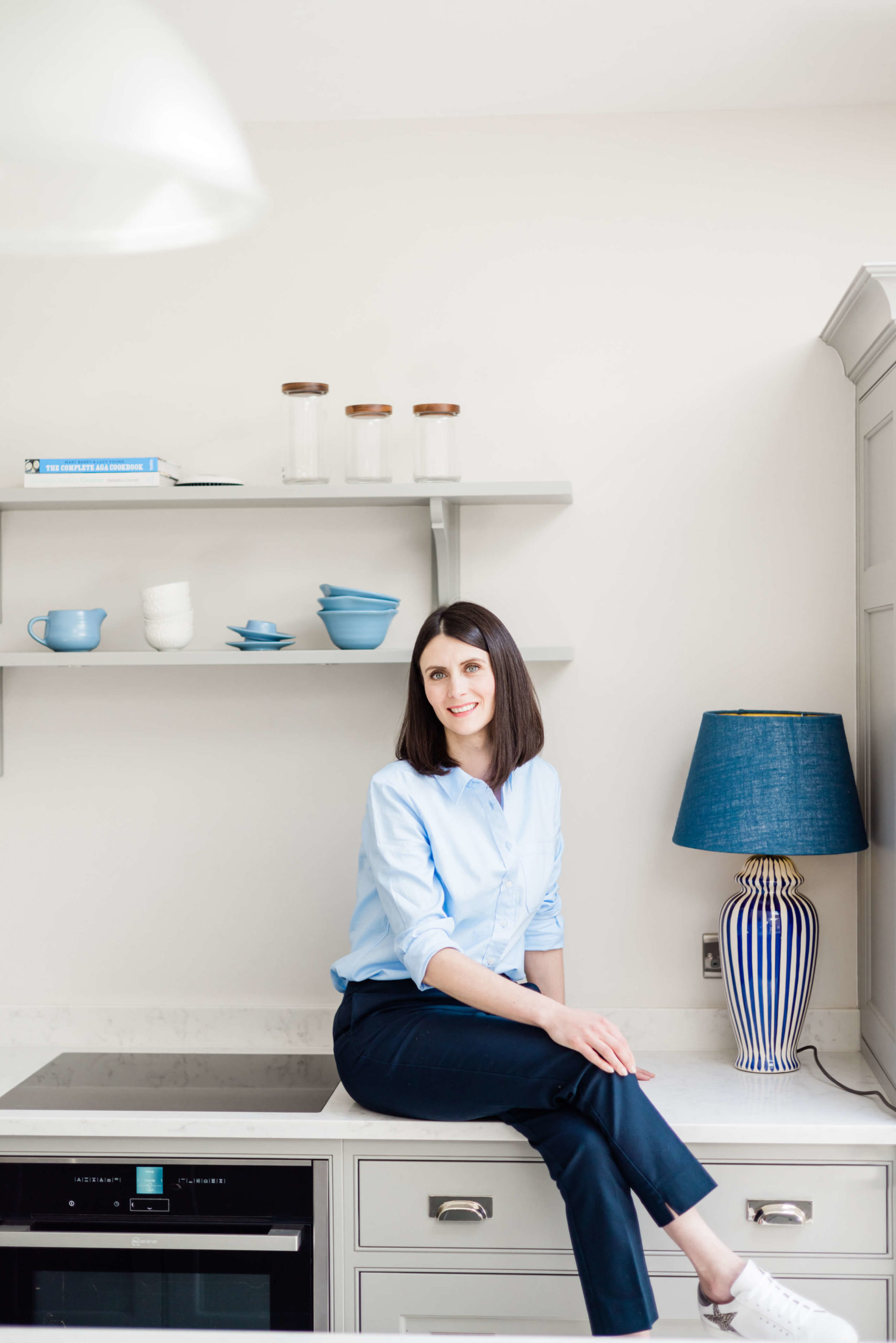 branding shoot styled in blue kitchen sat on counter captured by Kika Mitchell Photography