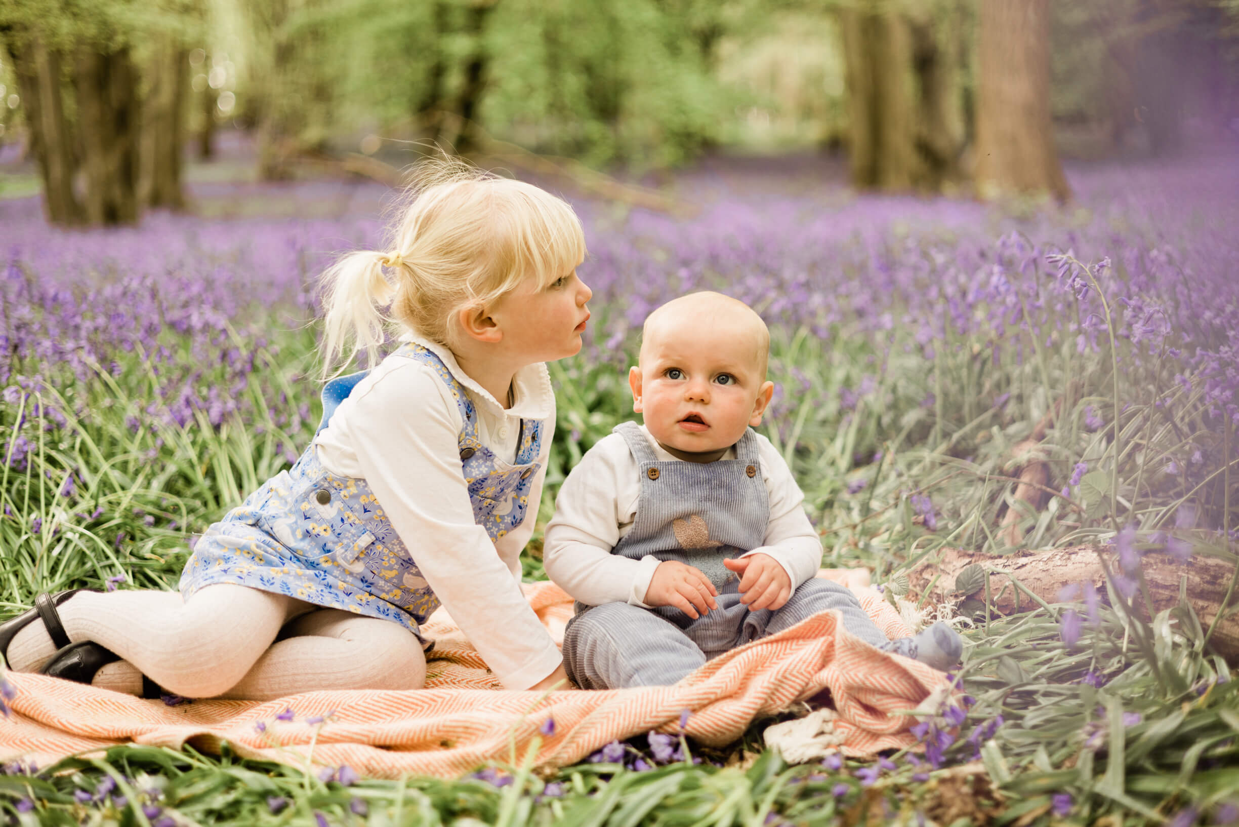 siblings in the blooming bluebells in their happy place by Chelmsford photographer Kika Mitchell Photographer