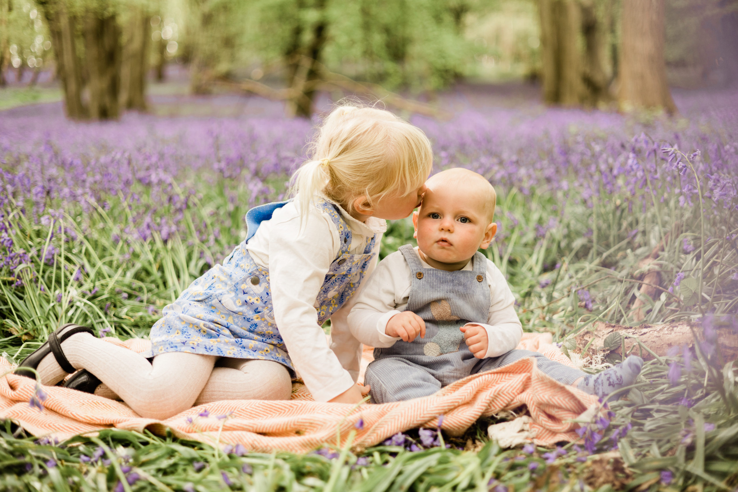 siblings in the blooming bluebells in their happy place by Chelmsford photographer Kika Mitchell Photographer