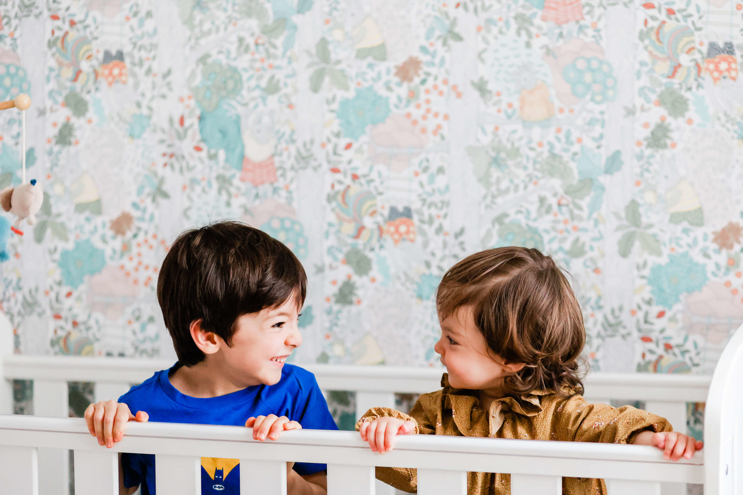 siblings in a cot by Chelmsford photographer Kika Mitchell Photography
